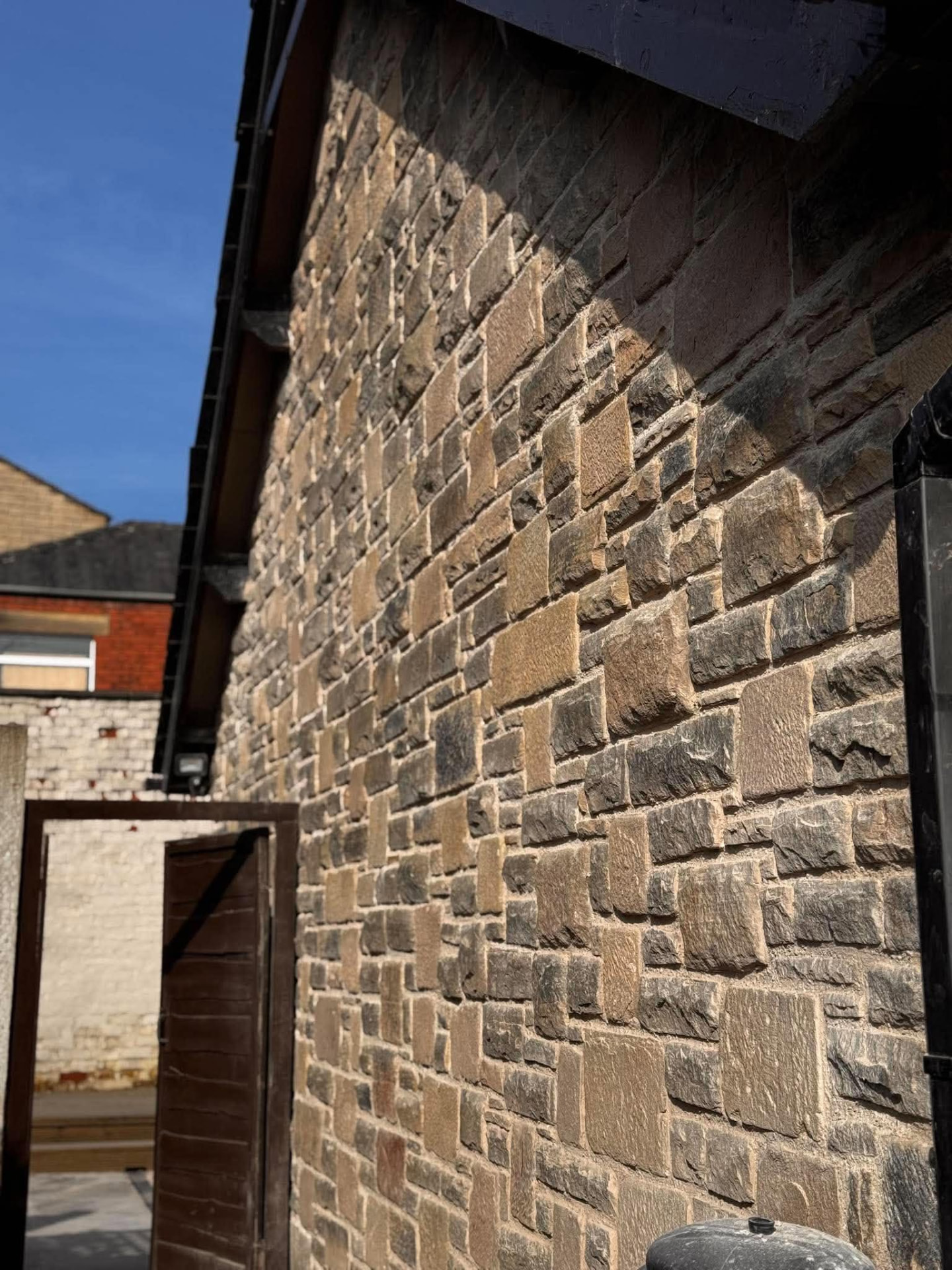 Dressed stone gable wall built with mortared masonry in a courtyard